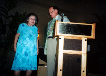 Dorothy Whitcomb is welcomed to the stage by Howard Weems